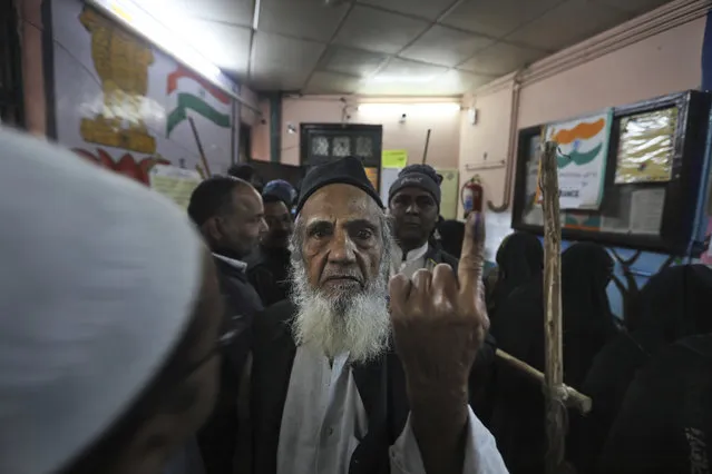 An elderly Muslim shows the indelible ink mark on his finger after casting his vote at a polling station in the old quarters of New Delhi, India, Saturday, February 8, 2020. Voting began for a crucial state election in India's capital on Saturday with Prime Minister Narendra Modi's Hindu nationalist party trying to regain power after a 22-year gap and major victories in a national vote. The BJP campaign has reopened old wounds in the Hindu-Muslim divide and treats the election as a referendum on nearly two months of protests across India against a new citizenship law that excludes Muslims. (Photo by Manish Swarup/AP Photo)