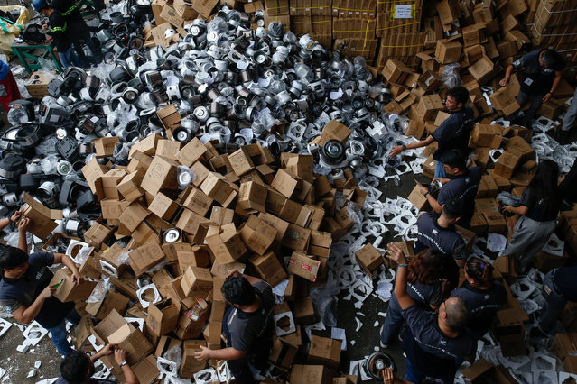 Uncertified cooking appliances are collected for mass destruction at a warehouse in Valenzuela City, Metro Manila, Philippines, 30 October 2024. A batch of 9,874 household appliances worth almost 7.8 million pesos (124,000 euros) were seized by government trade and industry authorities for violations of commercial and quality control certification laws in efforts to prevent unauthorized sales of substandard consumer goods. The latest seizure by the Department of Trade and Industry brings nationwide seizures of substandard products to a total worth of 297.9 million pesos (4.7 million euros). (Photo by Rolex dela Peña/EPA/EFE)