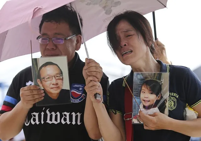 Relatives of passengers onboard the TransAsia Airways plane that crashed cry at a funeral parlor on Taiwan's offshore island of Penghu, July 24, 2014. Taiwan authorities launched an investigation on Thursday into the crash of a TransAsia Airways turboprop plane in which 48 people were killed with the weather expected to be a factor in the inquiry. (Photo by Edward Lau/Reuters)