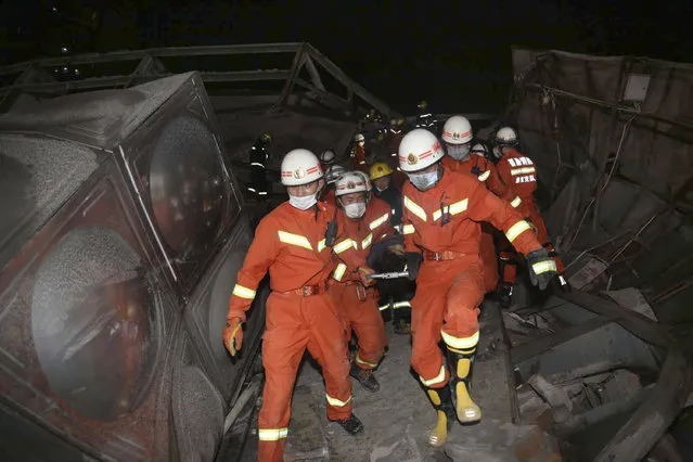 Rescuers evacuate an injured person from the rubble of a collapsed hotel building in Quanzhou city in southeast China's Fujian province Saturday, March 07, 2020. The hotel used for medical observation of people who had contact with coronavirus patients collapsed in southeastern China on Saturday, trapping dozens, state media reported. (Photo by Chinatopix via AP Photo)