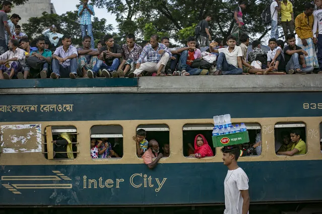 Bangladeshis travel by train to go home to their villages the day before Eid on September 1, 2017 in Dhaka, Bangladesh. Muslims worldwide celebrate Eid Al-Adha, to commemorate the Prophet Ibrahim's readiness to sacrifice his son as a sign of his obedience to God, during which they sacrifice permissible animals, generally goats, sheep, and cows. (Photo by Allison Joyce/Getty Images)