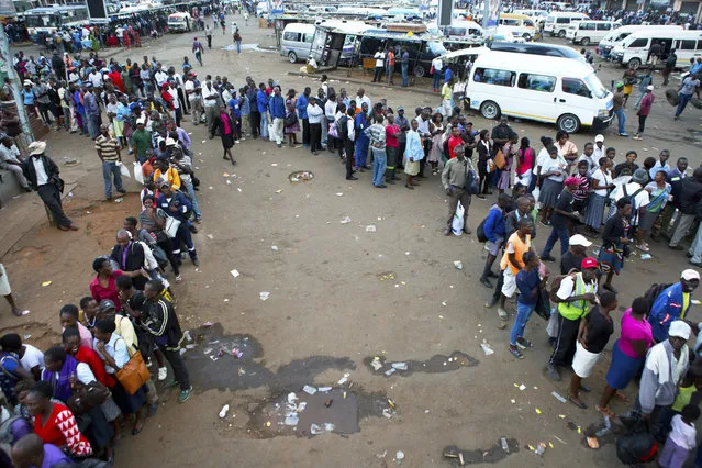 People queue for public transport in Harare, Zimbabwe, Monday, March, 23, 2020. Zimbabwe has closed its borders to non essential human traffic following its first recorded coronavirus related death. (Photo by Tsvangirayi Mukwazhi/AP Photo)