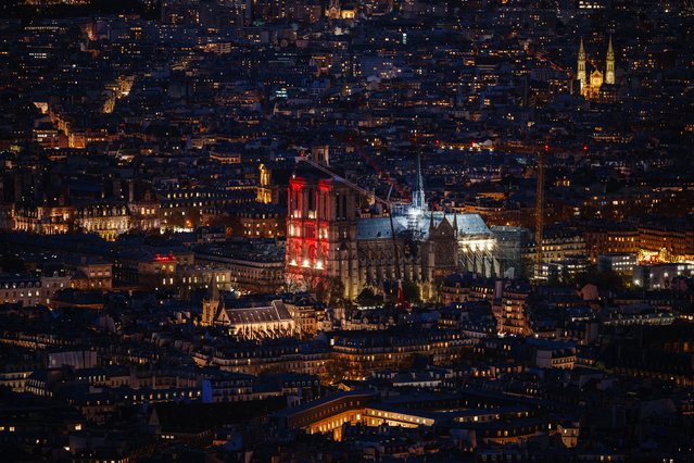 This photograph shows the Notre-Dame de Paris cathedral illuminated in red, as part of the “Red Week”, an event organised by the Aide à l'Église en Détresse (AED) association, to raise awareness to the plight of the Christian population persecuted for their faith, in Paris on November 20, 2024. (Photo by Dimitar Dilkoff/AFP Photo)