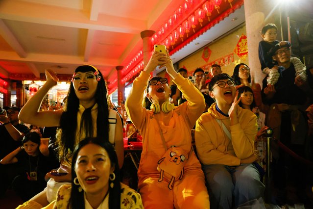 Fans of Nymphia Wind cheer during her performance at a local temple ahead of the annual pride parade in Taipei, Taiwan on October 21, 2023. (Photo by Ann Wang/Reuters)