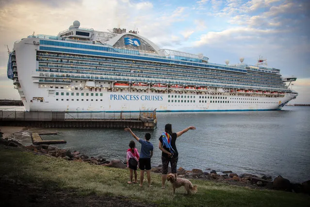 Local people watch the Ruby Princess cruise ship as she departs Port Kembla on April 23, 2020 in Wollongong, Australia. Australian Border Force has ordered the Ruby Princess to depart Australian waters today, as two separate inquiries continue over how the ship's 2700 passengers were allowed to disembark in Sydney in March without adequate health checks during the coronavirus (COVID-19) pandemic. A special commission of inquiry has been established by the NSW government over the handling of the Ruby Princess' arrival into Sydney on 19 March, while NSW Police are also conducting a separate criminal investigation. There are now 21 deaths linked to the Ruby Princess along with more than 600 confirmed coronavirus (COVID-19) cases. (Photo by James D. Morgan/Getty Images)