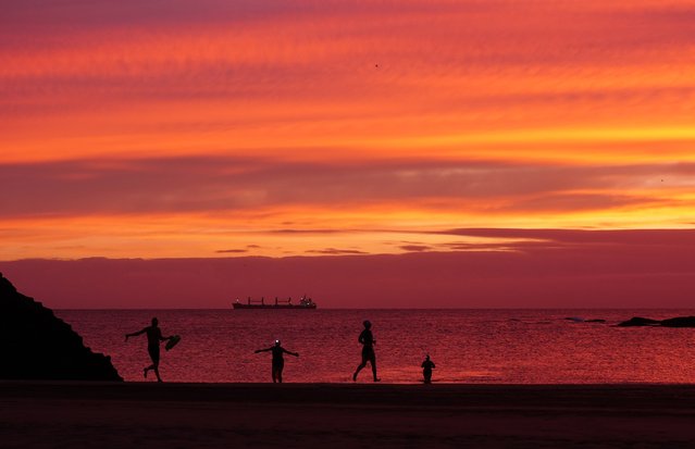 People on Cullercoats Beach, North Tyneside, UK at sunrise on Tuesday, November 12, 2024. (Photo by Owen Humphreys/PA Images via Getty Images)