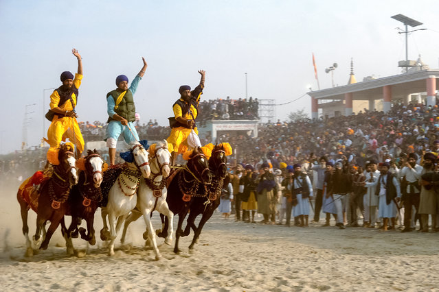 Nihang or Sikh warriors ride horses to mark the birth anniversary of the tenth Guru of the Sikhs, Guru Gobind Singh, at the Kangan Ghat in Patna on January 6, 2025. (Photo by Sachin Kumar/AFP Photo)