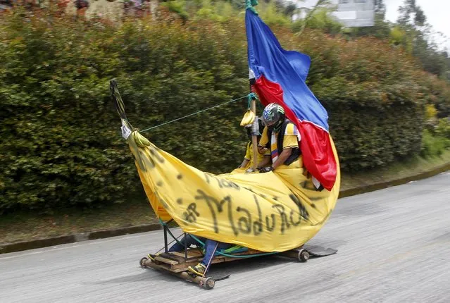 Participants descend a hill on a homemade cart during the 26th Roller Cart Festival in Medellin, Colombia September 6, 2015. (Photo by Fredy Builes/Reuters)