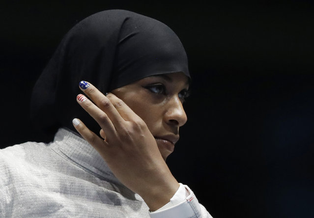 Ibtihaj Muhammad od the United States adjusts her hijab prior to competing with Olena Kravatska of Ukraine in the women's individual saber fencing event at the 2016 Summer Olympics in Rio de Janeiro, Brazil, Monday, August 8, 2016. (Photo by Andrew Medichini/AP Photo)