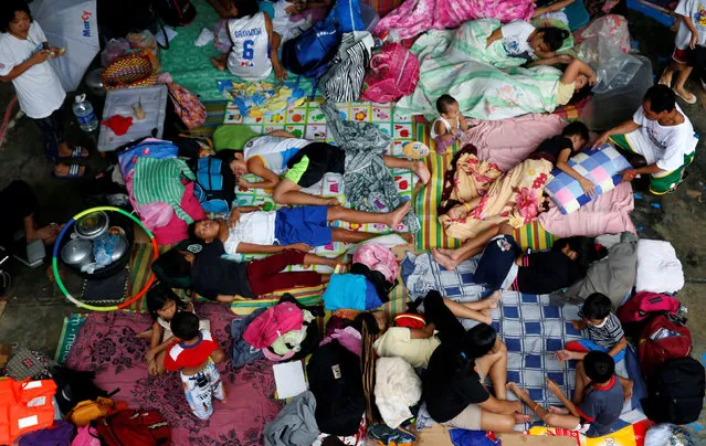 Flood victims take shelter at an evacuation centre after their homes were swamped by floods from monsoon rains in San Mateo, Rizal, Philippines, August 14, 2016. (Photo by Erik De Castro/Reuters)