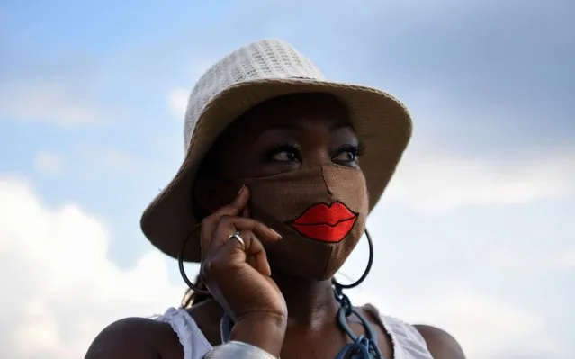A woman wears a mask as hundreds attend a vigil for George Floyd, whose death in Minneapolis police custody has sparked nationwide protests against racial inequality, at Jack Yates High School in Houston, Texas, U.S. June 8, 2020. (Photo by Callaghan O'Hare/Reuters)
