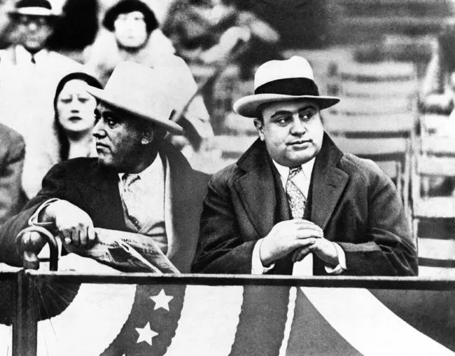 Al (Scarface) Capone, Chicago gangland “Big Shot”, shown on right in a choice front row seat while attending the Notre Dame and Northwestern Grid battle at Chicago, Illinois, on October 10, 1931. Capone probably figured a little sports diversion would relieve his mind, at least temporarily, of his run-in with the government on income tax violation charges. Former Alderman A.J. Prignano is on the left. (Photo by AP Photo)