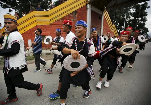 People dressed in traditional attire take part in a celebration a day after the first democratic constitution was announced in Kathmandu, Nepal, September 21, 2015. Nepal adopted its first full democratic constitution on Sunday, a historic step for a nation that has witnessed war, a palace massacre and devastating earthquakes since a campaign to create a modern state began more than 65 years ago. (Photo by Navesh Chitrakar/Reuters)