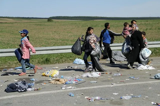 Migrants walk as they cross the border from Serbia near Tovarnik, Croatia September 21, 2015. Croatia will demand that Greece stop moving migrants from the Middle East on to the rest of Europe, Interior Minister Ranko Ostojic said on Monday. (Photo by Antonio Bronic/Reuters)