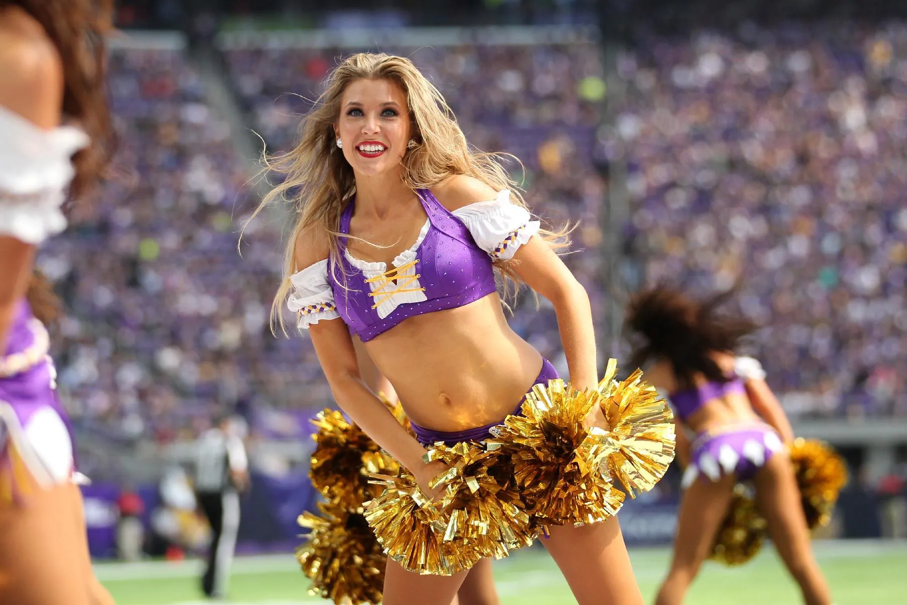 A Minnesota Vikings cheerleader performs during the second half of an NFL p...