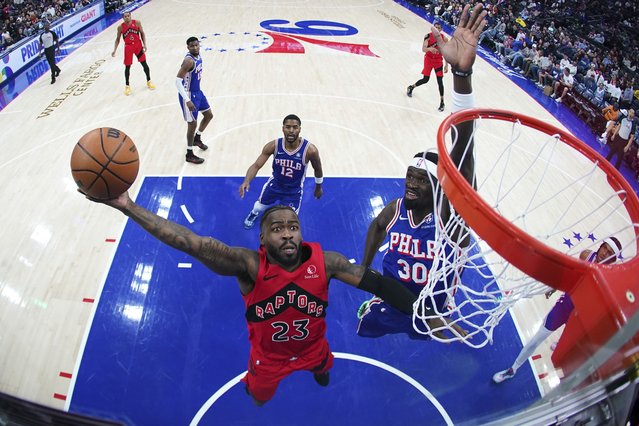 Toronto Raptors' Jamal Shead, left, goes up for a shot against Philadelphia 76ers' Adem Bona during the first half of an NBA basketball game Sunday, March 30, 2025, in Philadelphia. (Photo by Matt Slocum/AP Photo)