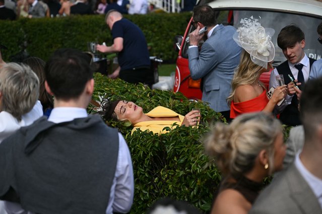 A racegoer relaxes on day two of the Grand National Festival horse race meeting at Aintree Racecourse in Liverpool, north-west England, on April 4, 2025. (Photo by Oli Scarff/AFP Photo)