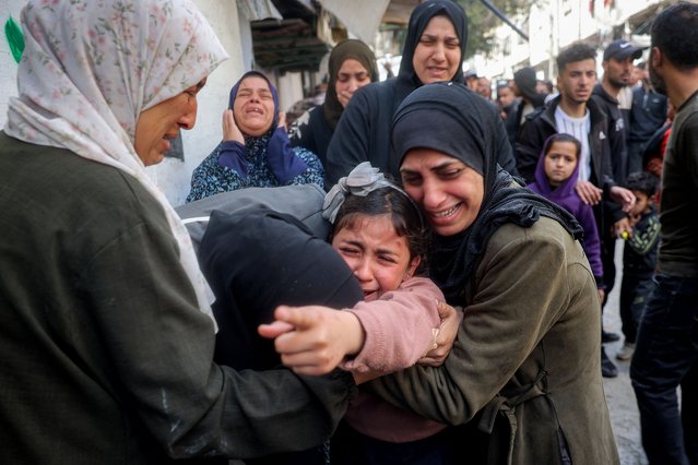 The young sister (C) mourns for her siblings and other members from the Abu al-Rous family who were killed when their house was hit by Israeli bombardment, during the funeral at the Bureij camp for Palestinian refugees in the central Gaza Strip on March 25, 2025. Israel, vowing to destroy Palestinian militant group Hamas, on March 18 resumed intense bombardment of Gaza and redeployed ground troops, shattering a truce that had largely held since January 19. (Photo by Eyad Baba/AFP Photo)