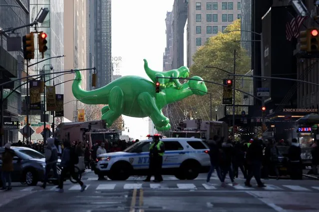 The Sinclair's Dino balloon flies during the 96th Macy's Thanksgiving Day Parade in Manhattan, New York City, U.S., November 24, 2022. (Photo by Andrew Kelly/Reuters)