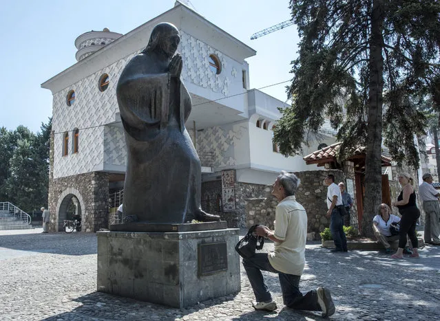 Believer plrays in front of the monument and memorial house of Mother Theresa in Skopje, the Former Yugoslav Republic of Macedonia on 4 September 2016. Mother Teresa was born Agnes Gonxha Bojaxhiu on 26 August 1910 to Albanian parents in Skopje, Macedonia. She began her missionary work with the poor in Calcutta in 1948, and won the Nobel Peace Prize in 1979. Following her death in 1997 she was beatified by Pope John Paul II and given the title Blessed Teresa of Calcutta. Mother Teresa was canonized today by Pope Francis in Vatican. (Photo by Georgi Licovski/EPA)
