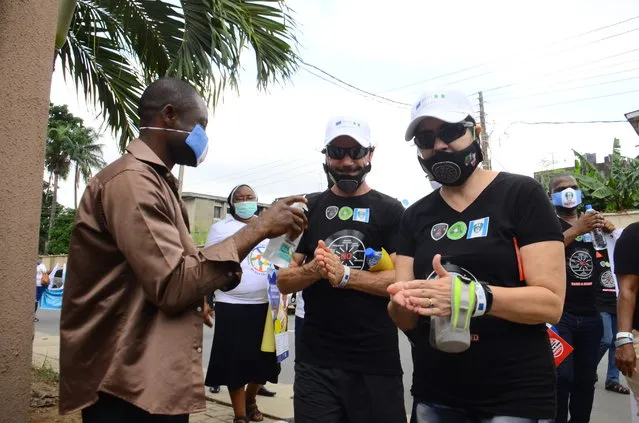 Activists sanitize their hands upon arrival after Mindful Giving Changes Lives walk in recognition of the World Day Against Trafficking in Persons in Lagos, on July 30, 2020.  (Photo by Olukayode Jaiyeola/NurPhoto via Getty Images)