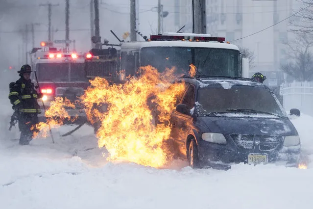 Firefighters extinguish a vehicle fire during a winter snowstorm in Atlantic City, N.J., Thursday, January 4, 2018. (Photo by Matt Rourke/AP Photo)