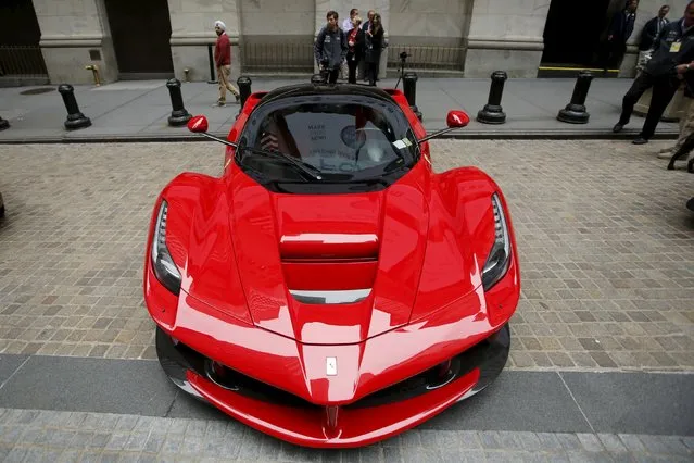 A Ferrari car is parked at the entrance of the New York Stock Exchange in New York in this October 13, 2014 file photo. Sources say Ferrari, famous for its prancing horse logo and Formula One racing team, should make its debut on Wall Street in the week starting October 12, 2015, the first step in its separation from parent Fiat Chrysler Automobiles (FCA). (Photo by Eduardo Munoz/Reuters)