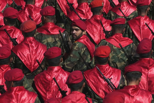 An Iranian army member, center, looks back, among others, as they conclude their march, during a parade commemorating National Army Day in front of the shrine of the late revolutionary founder Ayatollah Khomeini, just outside Tehran, Iran, Friday, April 18, 2025. (Photo by Vahid Salemi/AP Photo)