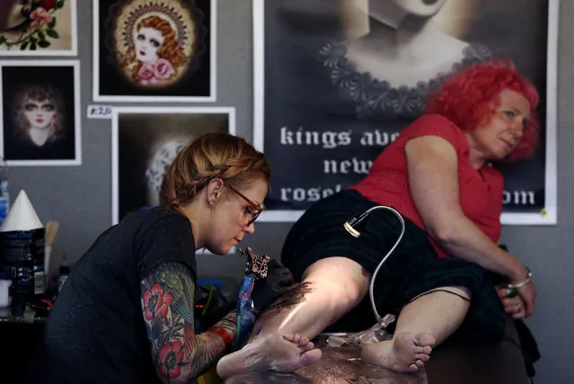 A woman is tattooed at the International London Tattoo Convention in London, Britain September 23, 2016. (Photo by Neil Hall/Reuters)