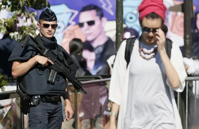 An armed French policeman maintains a security presence during the17th edition of the Techno Parade music event in Paris, France, September 24, 2016. (Photo by Gonzalo Fuentes/Reuters)