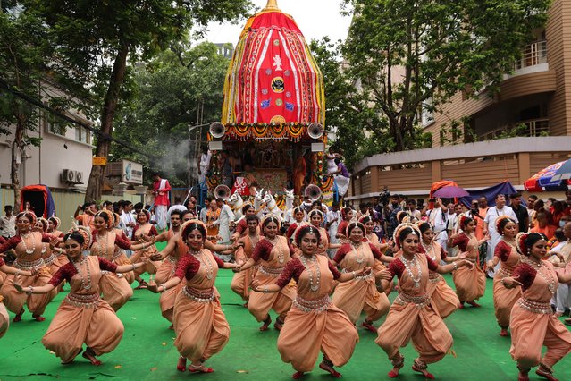 Indian devotees perform a holy dance near a holy chariot bearing Lord Jagannatha during Rath Yatra or Chariot Journey Festival organized by the International Society for Krishna Consciousness (ISKCON) in Kolkata, India, 27 June 2025. The Jagannath Rath Yatra festival or pulling of the chariots is one of the most important Hindu festivals in India. (Photo by Piyal Adhikary/EPA)