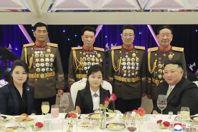 In this photo provided by the North Korean government, North Korean leader Kim Jong Un, right, with his wife Ri Sol Ju, left, and his daughter poses with military top officials for a photo at a feast to mark the 75th founding anniversary of the Korean People’s Army at an unspecified place in North Korea Tuesday, February 7, 2023. Independent journalists were not given access to cover the event depicted in this image distributed by the North Korean government. The content of this image is as provided and cannot be independently verified. Korean language watermark on image as provided by source reads: “KCNA” which is the abbreviation for Korean Central News Agency. (Photo by Korean Central News Agency/Korea News Service via AP Photo)
