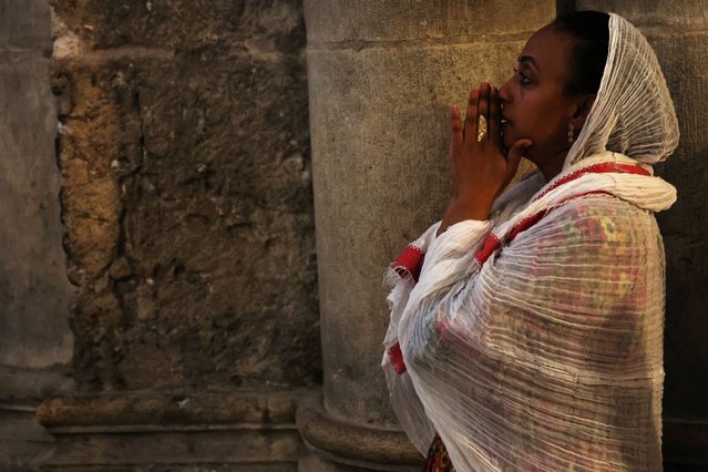 An Orthodox Christian worshipper prays inside the Church of the Holy Sepulchre, on the day of a Good Friday procession along the Via Dolorosa in Jerusalem's Old City, on May 3, 2024. (Photo by Shannon Stapleton/Reuters)