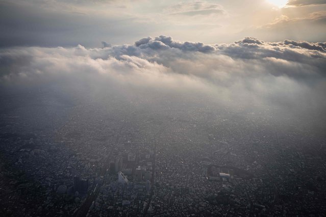 This picture taken from the window of a passenger jet shows an aerial view of the Nakano area of Tokyo on May 21, 2024. (Photo by Yuichi Yamazaki/AFP Photo)
