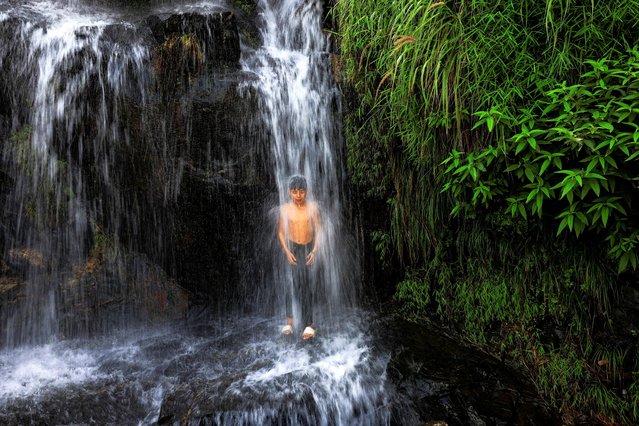 A boy cools off under a waterfall on the outskirts of Sowari, in Buner District, in Khyber Pakhtunkhwa province, Pakistan, on August 20, 2025. (Photo by Akhtar Soomro/Reuters)