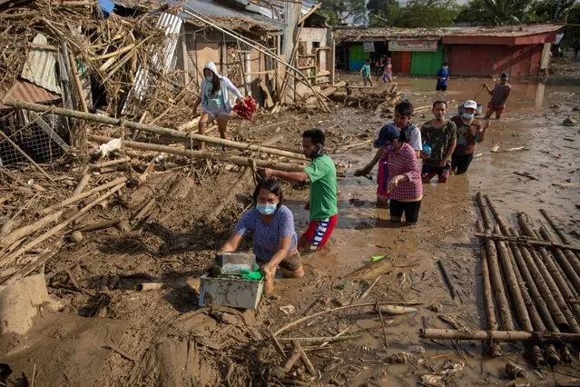 Residents retrieve belongings from their submerged village following floods caused by Typhoon Vamco, in Rodriguez, Rizal province, Philippines, November 14, 2020. (Photo by Eloisa Lopez/Reuters)