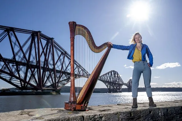 Composer, harpist and singer Esther Swift alongside her Italian Salvi pedal harp during a photocall ahead of her upcoming tour, at the Forth Bridge in North Queensferry, Scotland on Tuesday, March 7, 2023. Ms Swift will tour across Scotland solo this month with a programme of original compositions and traditional works. (Photo by Jane Barlow/PA Images via Getty Images)