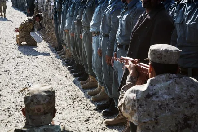 Afghan National police officers demonstrate their training during a visit by U.S. Brigadier General Christopher Bentley to an Afghan National police installation in the Nangarhar province of Afghanistan December 16, 2014. (Photo by Lucas Jackson/Reuters)