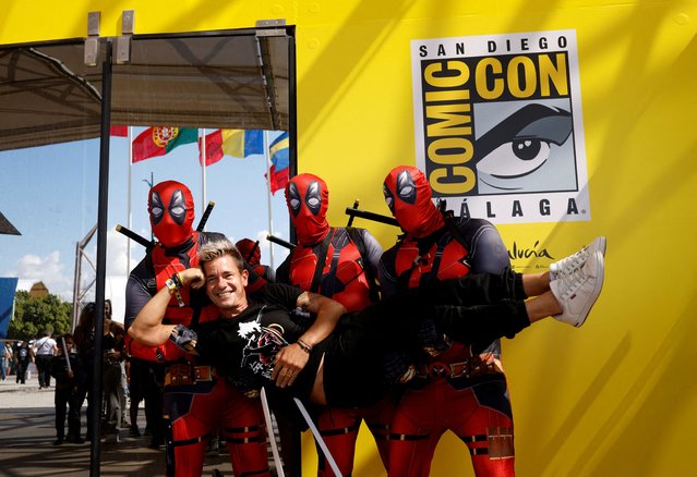 Cosplayers dressed as Deadpool hold a visitor for a picture during the San Diego Comic-Con Malaga, in Malaga, Spain on September 25, 2025. (Photo by Marcelo del Pozo/Reuters)