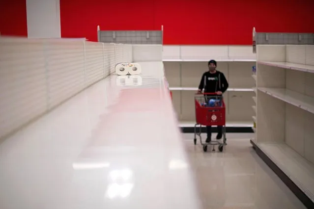 A lone package of paper towels remains on bare shelves due to the coronavirus disease (COVID-19) pandemic at a Target store in King of Prussia, Pennsylvania U.S. November 20, 2020. (Photo by Mark Makela/Reuters)