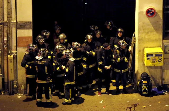 French fire brigade members gather near the Bataclan concert hall following fatal shootings in Paris, November 14, 2015. (Photo by Christian Hartmann/Reuters)