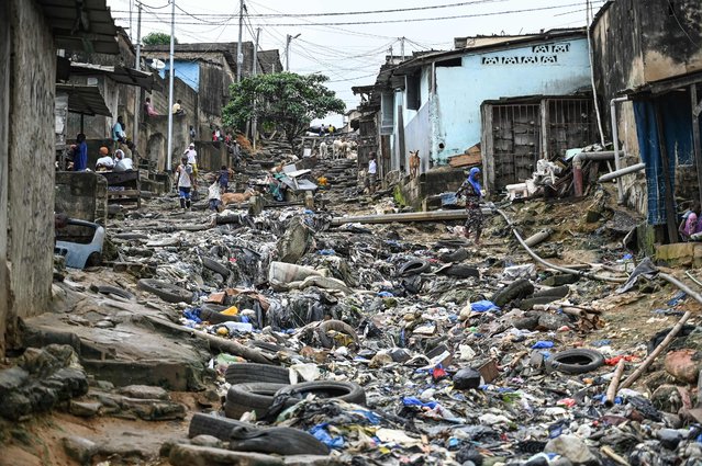 A general view of a street littered with plastic waste in the popular commune of Attecoube, Abidjan, Ivory Coast on June 10, 2024. (Photo by Sia Kambou/AFP Photo)