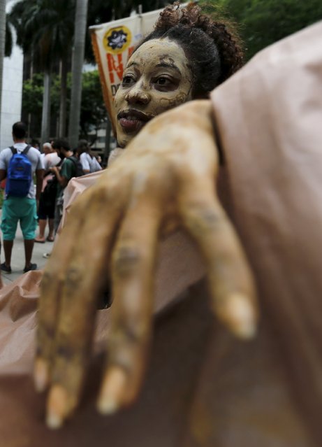 An environmental activist performs during a protest in front of the headquarters of Brazilian mining company Vale SA in downtown Rio de Janeiro, Brazil, November 16, 2015. (Photo by Sergio Moraes/Reuters)