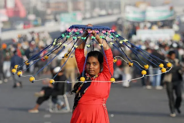 A girl performs the Gatka, a traditional form of martial art, as farmers take part in a protest against farm bills passed by India's parliament at Delhi-Uttar Pradesh border on the outskirts of Delhi, India, December 17, 2020. (Photo by Anushree Fadnavis/Reuters)