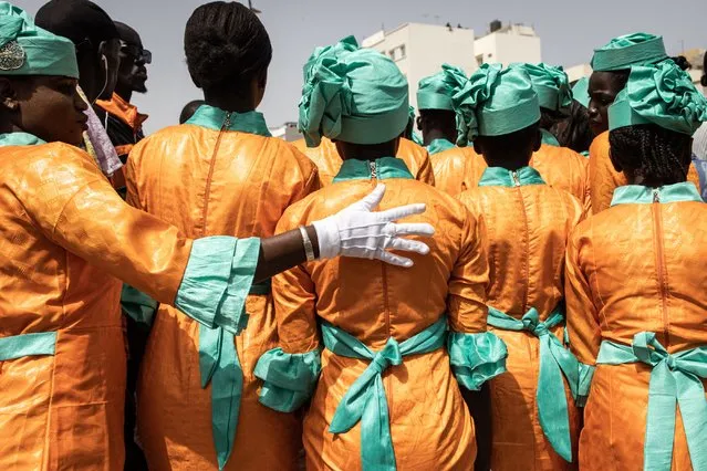 School girls gets ready to take part in celebrations for Senegal's 63rd Independence Day in Dakar on April 04, 2023. (Photo by John Wessels/AFP Photo)