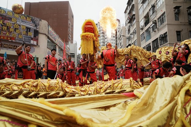 Participants preform the dragon dance and fire breathing during a parade celebrating Tin Hau festival at Yuen Long district, in Hong Kong, China on May 12, 2023. (Photo by Lam Yik/Reuters)