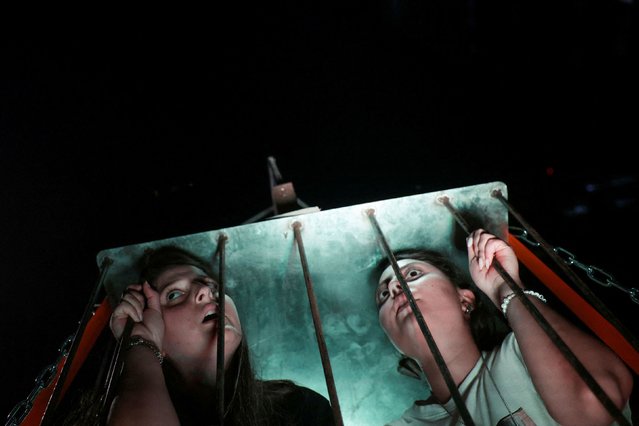 Demonstrators in Tel Aviv, Israel, sit inside a cage on Thursday, August 1, 2024 as they take part in a march calling for an immediate release of hostages being held in Gaza. The march also marked 300 days since Hamas’ deadly attack in October. (Photo by Ricardo Moraes/Reuters)