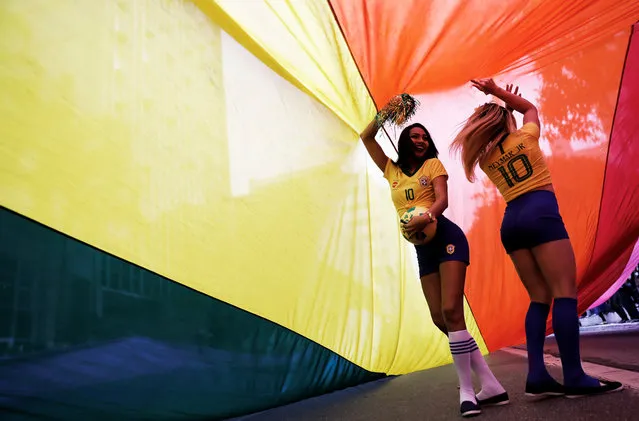Revellers dressed as Brazilian soccer player Neymar as they dance under a rainbow flag during the Gay Pride parade along Paulista Avenue in Sao Paulo, Brazil June 3, 2018. (Photo by Nacho Doce/Reuters)