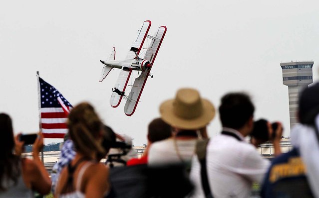 Wicker waves at the Vectren Dayton Air Show crowd seconds before the plane hit the ground, killing her and the pilot at approximately 12:45 p.m. (Photo by Darin Pope/Dayton Daily News)