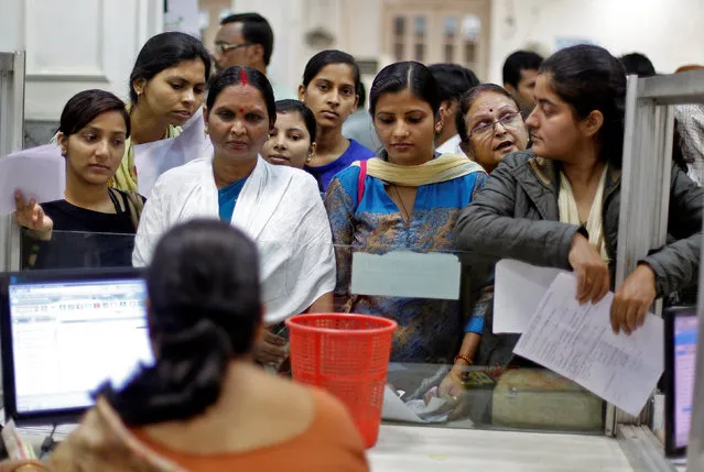 People queue to deposit 500 and 1000 Indian rupee banknotes inside a bank in Allahabad, India November 11, 2016. (Photo by Jitendra Prakash/Reuters)